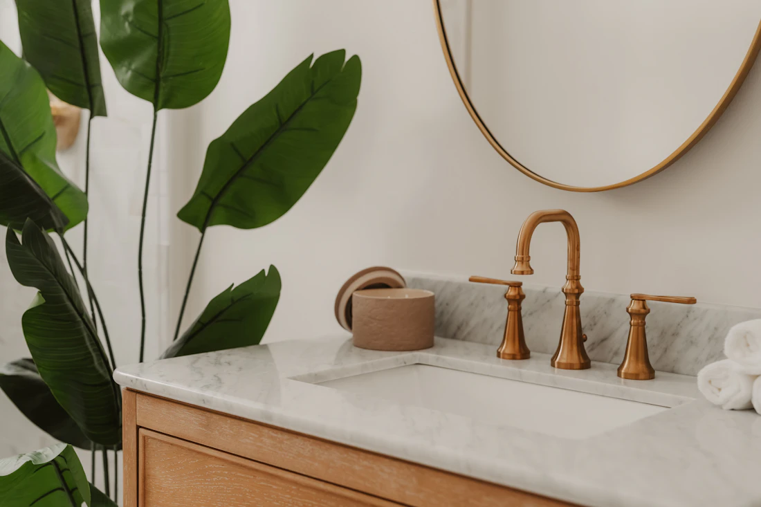 Clean bathroom vanity with polished taps and fresh towels
