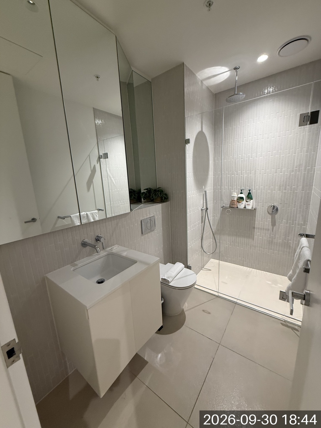 Shower, basin and towels in a bathroom photographed during a Melbourne cleaning job