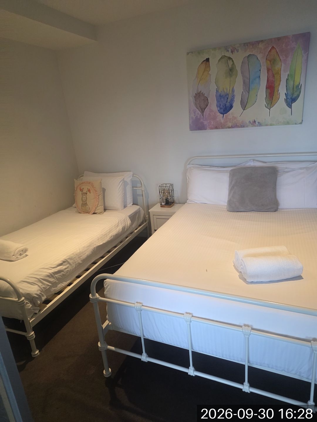 Prepared beds with white bedding and towels in a Melbourne property