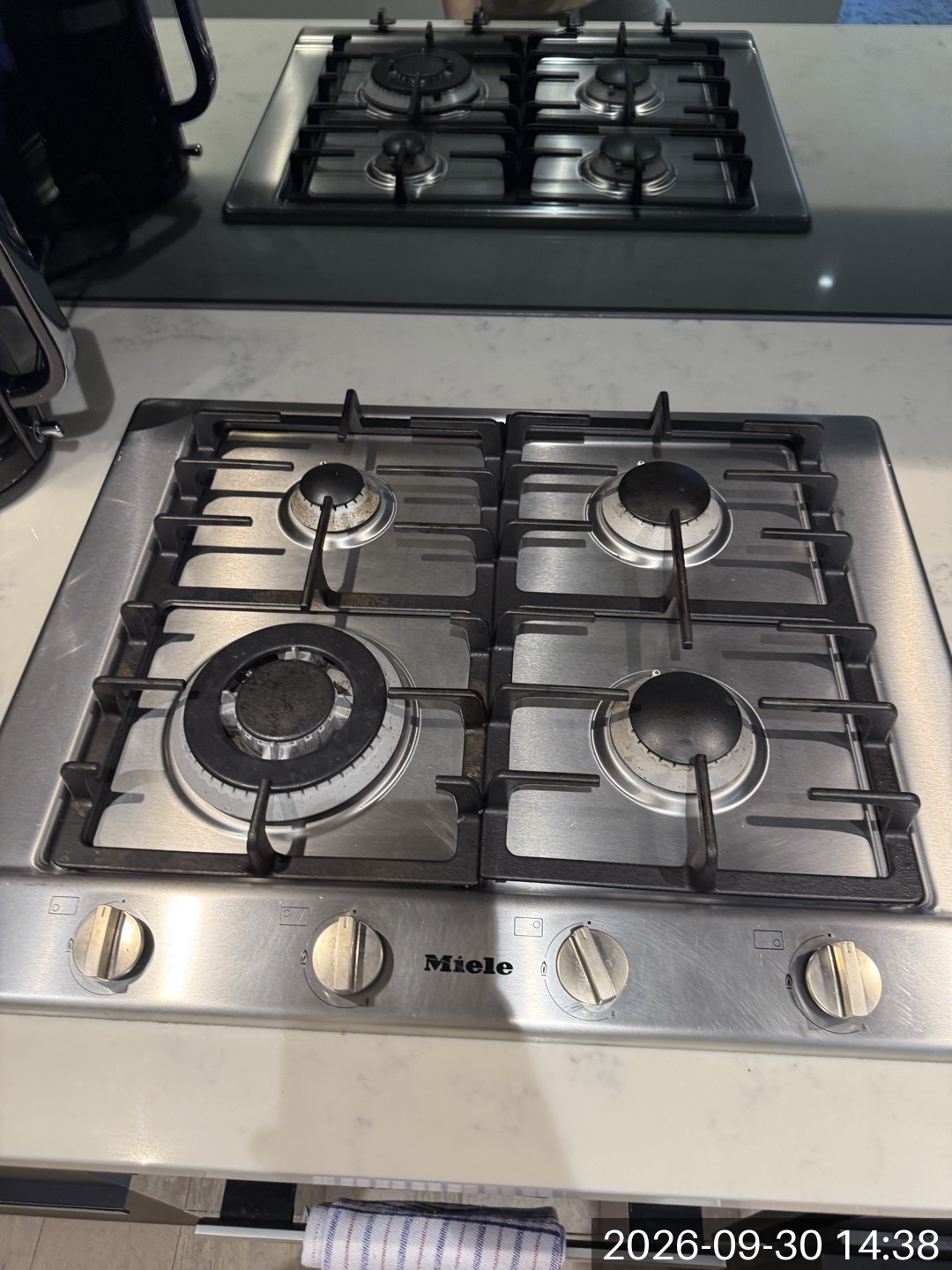 Stovetop and surrounding bench photographed during a Melbourne cleaning job
