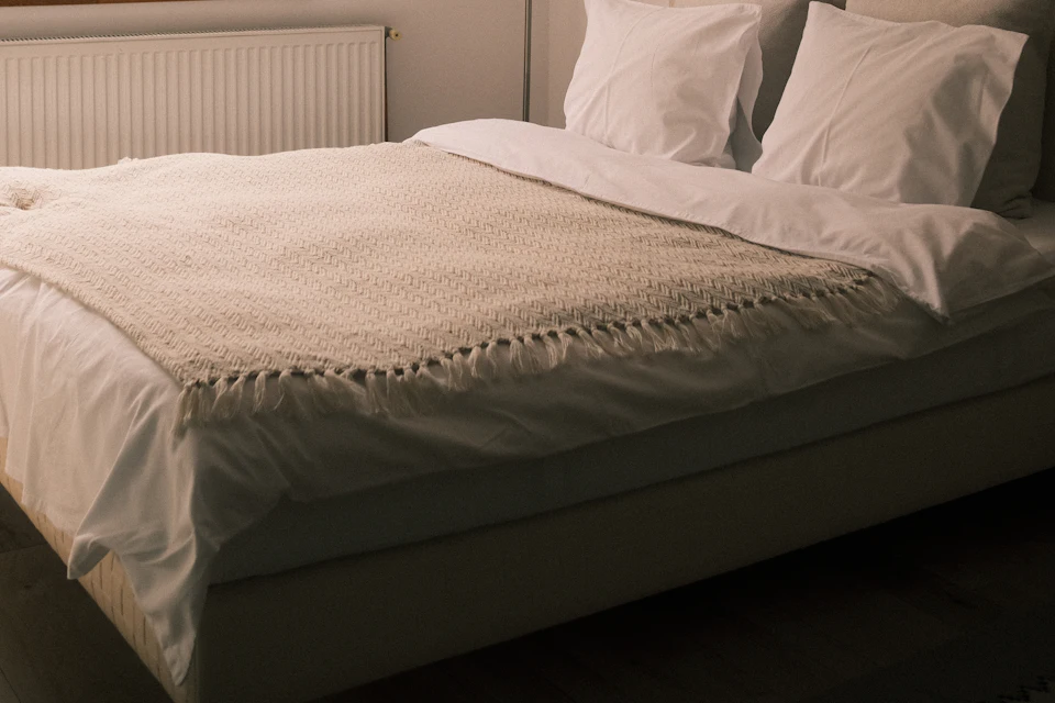 Fresh white bedding in a sunlit bedroom